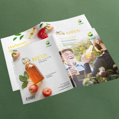 Individuell gestaltete Broschueren vor grünem Hintergrund