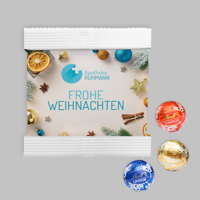 Lindor 3er Kugeln in individuell bedruckter Papiertüte auf grauem Hintergrund