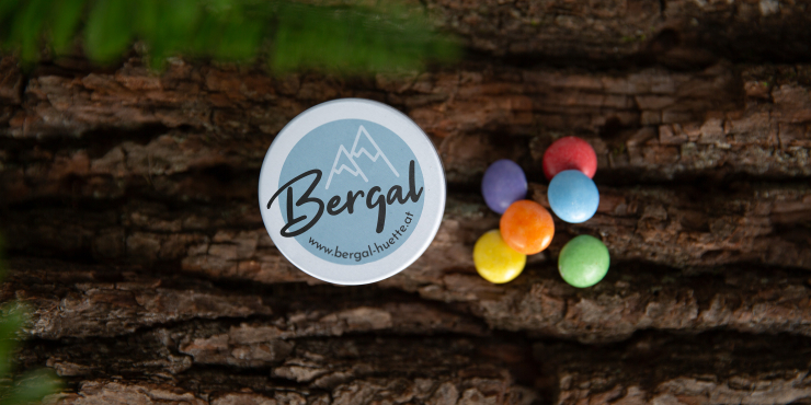 Individuell gestaltete XS-Dose auf Tisch mit bunten Schokolinsen daneben