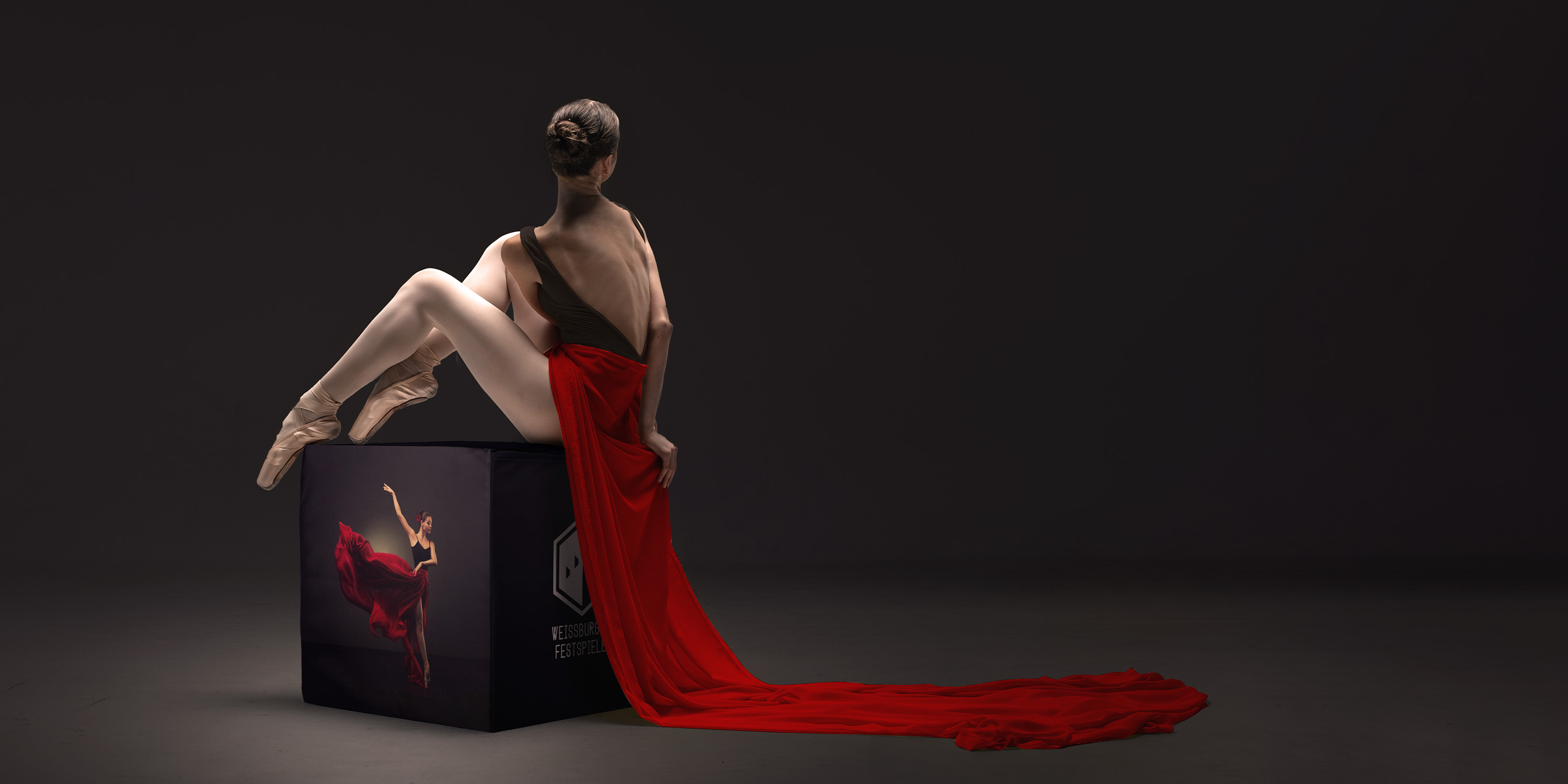 Ballerina sitzt auf Sitzwürfel mit der Grösse 50 x 50 x 50 cm