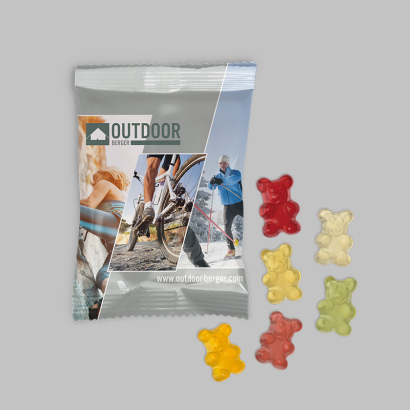 Individuell gestaltete Fruchtgummi 10g Verpackung vegan vor grauem Hintergrund