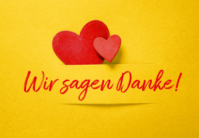 Gelber Hintergrund mit großen roten Herz und kleinen dunkelrosigen Herz mit der roten Aufschrift "Wir sagen Danke!"