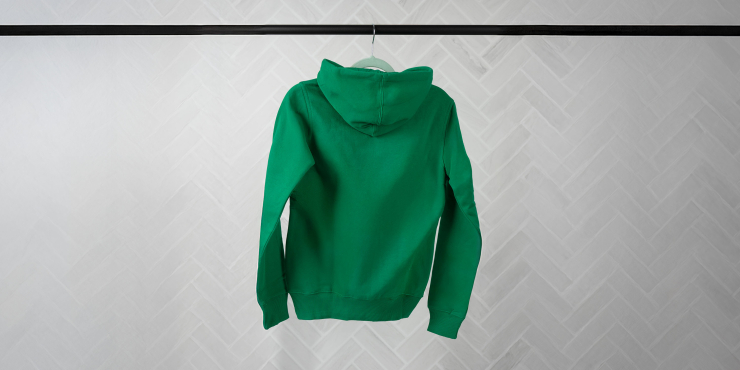 Dunkelgrüner Printer-Hoodie von der Rückseite hängend auf einer schwarzen Kleiderstange