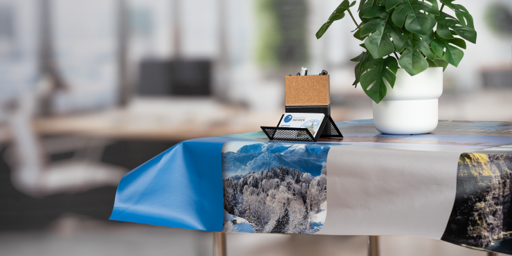 Bedruckte PVC-Tischdecke mit einer Pflanze und einem Visitenkartenständer